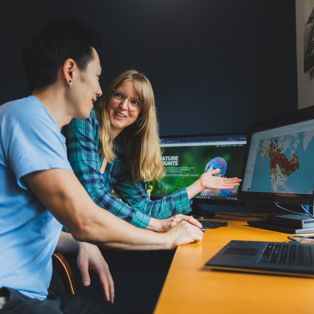 Two people using NatureCounts on a computer.