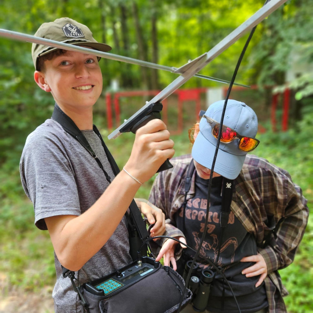 Two Young Ornithologist Workshop participants working with radio telemetry equipment.