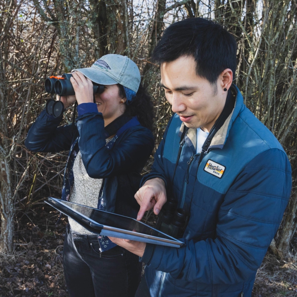 Two people use NatureCounts in the field.